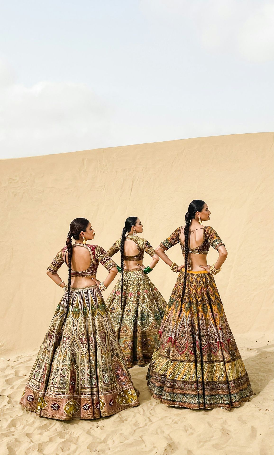 A group of women standing on top of a sandy beach